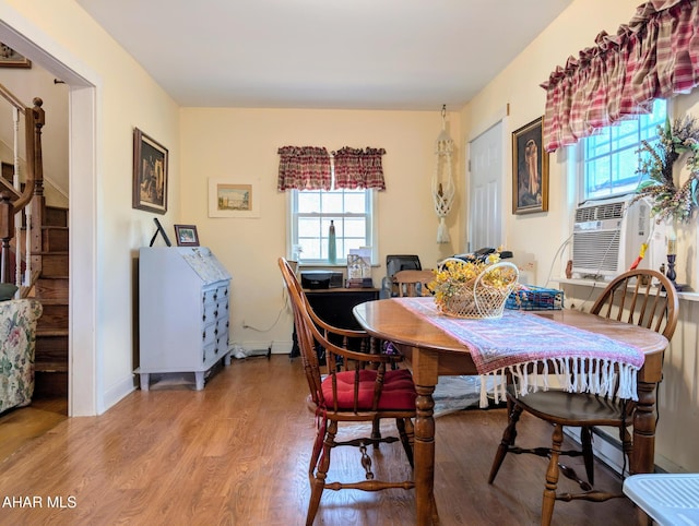 dining room with cooling unit and wood-type flooring