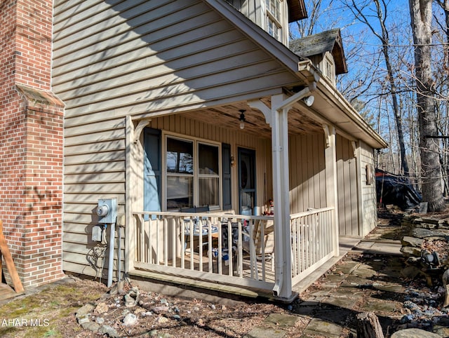 doorway to property with ceiling fan and a porch