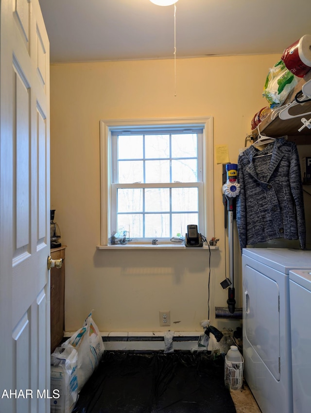 laundry area featuring washing machine and clothes dryer and a baseboard radiator