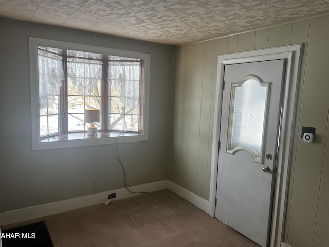 doorway with carpet and baseboards