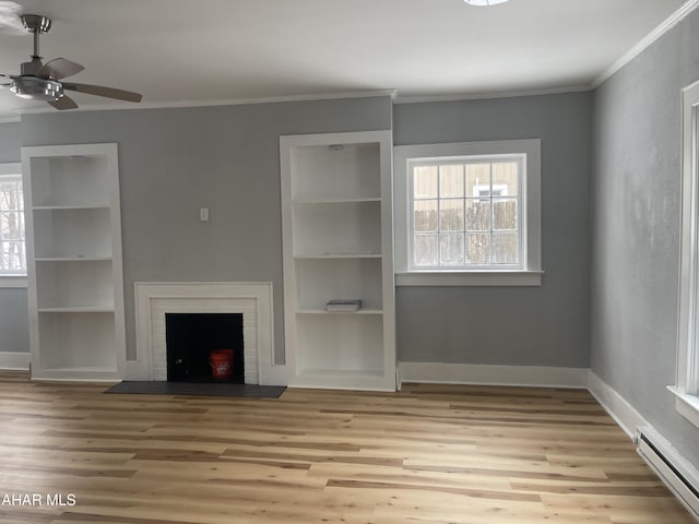 unfurnished living room with a baseboard heating unit, ornamental molding, light wood-type flooring, and a brick fireplace