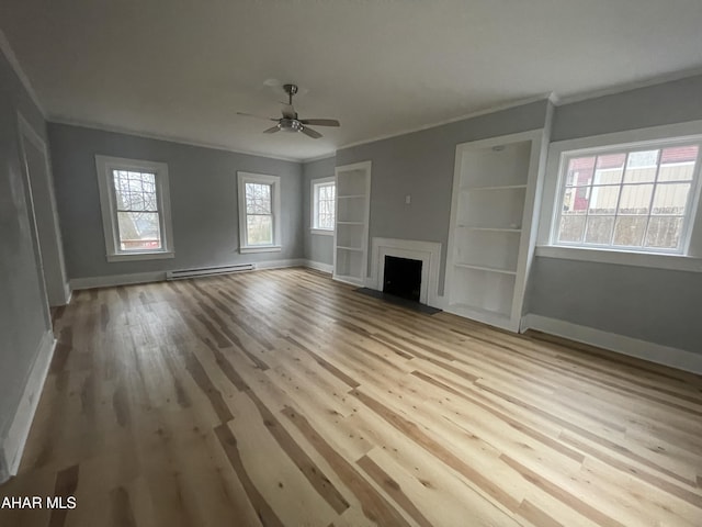 unfurnished living room featuring a fireplace, a baseboard heating unit, wood finished floors, and ornamental molding