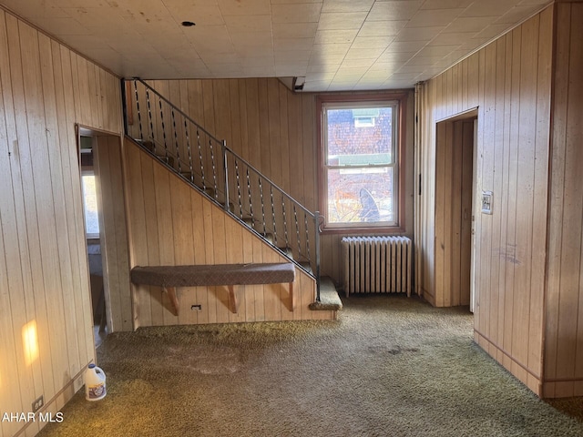 interior space with wood walls and radiator