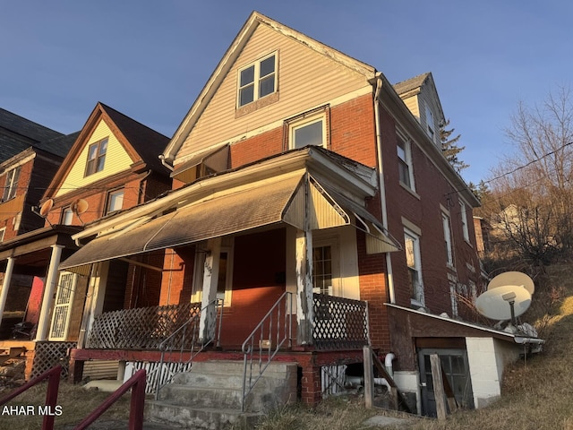 back of property with a porch