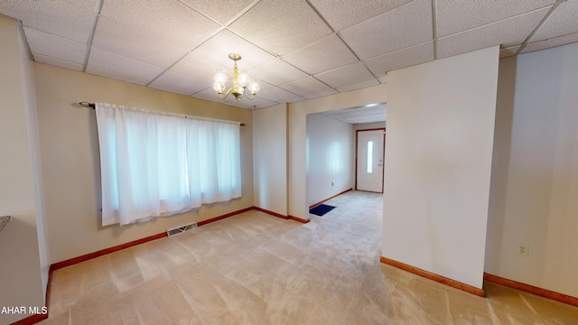 602 5th Ave, Altoona, PA 16602 - empty room with plenty of natural light, a chandelier, carpet floors, baseboards, and a drop ceiling
