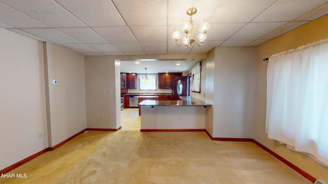 602 5th Ave, Altoona, PA 16602 - kitchen featuring light carpet, a chandelier, a peninsula, dark countertops, and stainless steel dishwasher