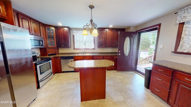 602 5th Ave, Altoona, PA 16602 - kitchen featuring stainless steel appliances, a sink, a kitchen island, hanging light fixtures, and dark brown cabinets
