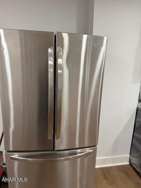 2306 5th Ave, Altoona, PA 16602 - detailed view of freestanding refrigerator, wood finished floors, and baseboards