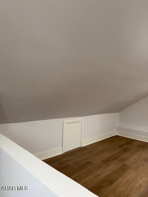 2306 5th Ave, Altoona, PA 16602 - additional living space featuring vaulted ceiling, baseboards, and dark wood-type flooring