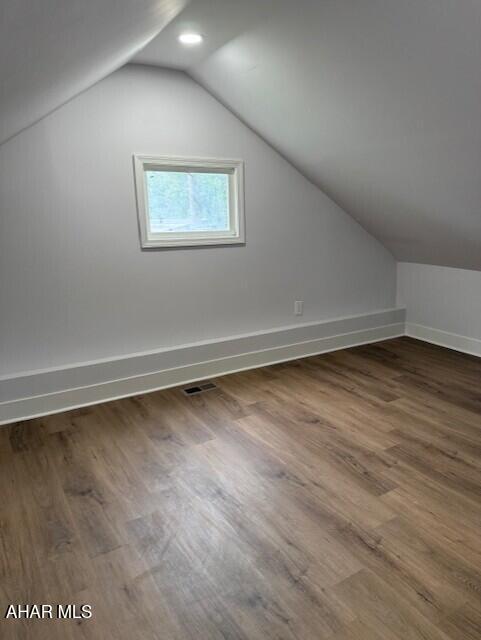 2306 5th Ave, Altoona, PA 16602 - additional living space featuring lofted ceiling, dark wood-style flooring, and baseboards