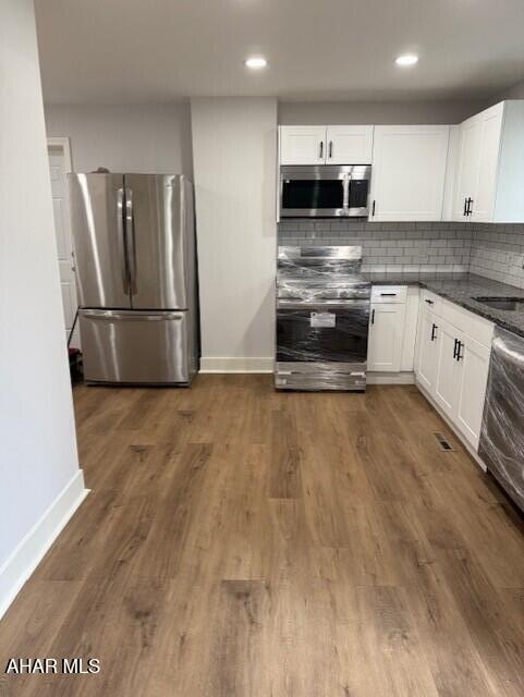 2306 5th Ave, Altoona, PA 16602 - kitchen with stainless steel appliances, baseboards, white cabinets, and recessed lighting