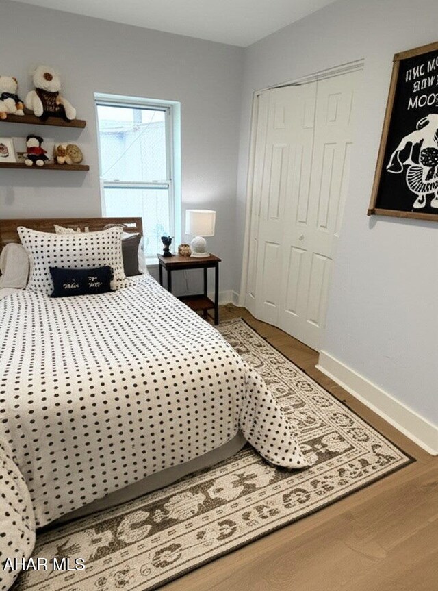 2306 5th Ave, Altoona, PA 16602 - bedroom with baseboards, wood finished floors, and a closet