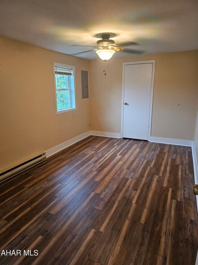 2754 Everett Rd, East Freedom, PA 16637 - unfurnished room with electric panel, baseboard heating, a ceiling fan, dark wood-type flooring, and baseboards