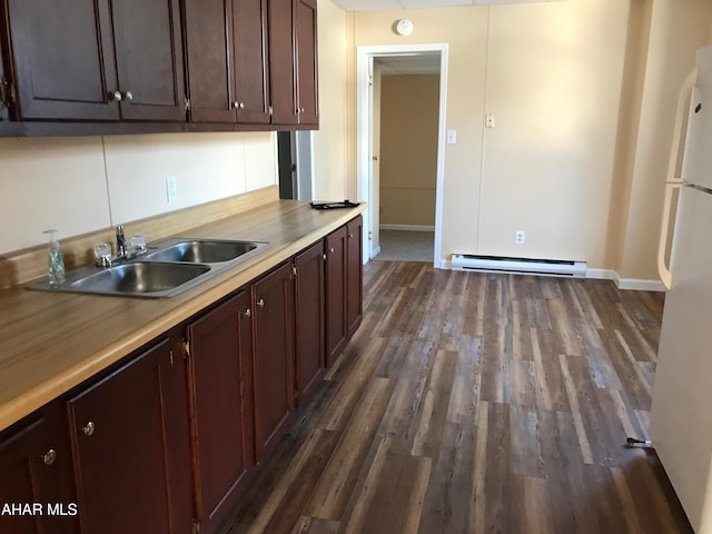 2754 Everett Rd, East Freedom, PA 16637 - kitchen featuring a baseboard heating unit, dark wood finished floors, baseboards, and a sink