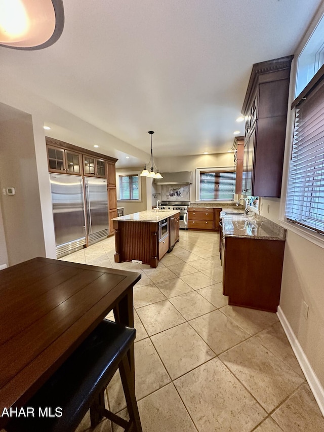 3405 Crescent Rd, Altoona, PA 16602 - kitchen featuring premium appliances, glass insert cabinets, light tile patterned flooring, recessed lighting, and hanging light fixtures