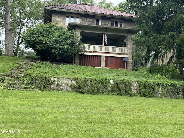 3405 Crescent Rd, Altoona, PA 16602 - rear view of house with stone siding, a balcony, a yard, and a tiled roof
