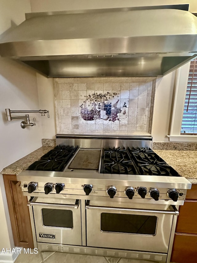 3405 Crescent Rd, Altoona, PA 16602 - kitchen featuring double oven range, light stone counters, wall chimney exhaust hood, and decorative backsplash