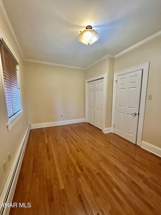 3405 Crescent Rd, Altoona, PA 16602 - unfurnished bedroom featuring a baseboard radiator, wood finished floors, a closet, baseboards, and ornamental molding