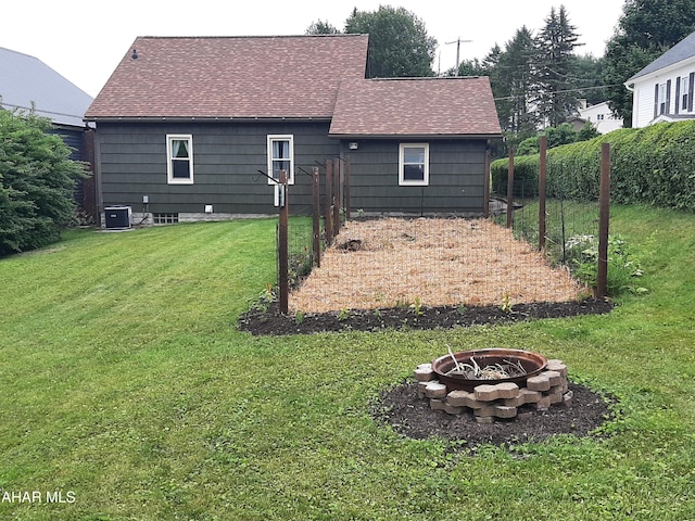 735 N Julian St, Ebensburg, PA 15931 - back of property with a fire pit, a shingled roof, and central AC