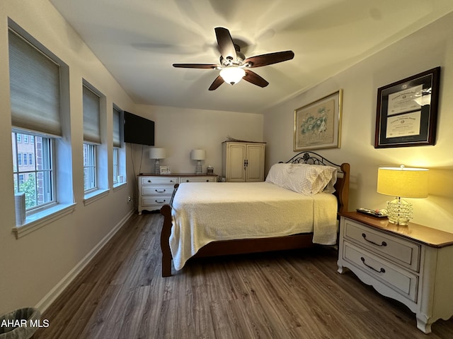 bedroom with ceiling fan and dark hardwood / wood-style floors