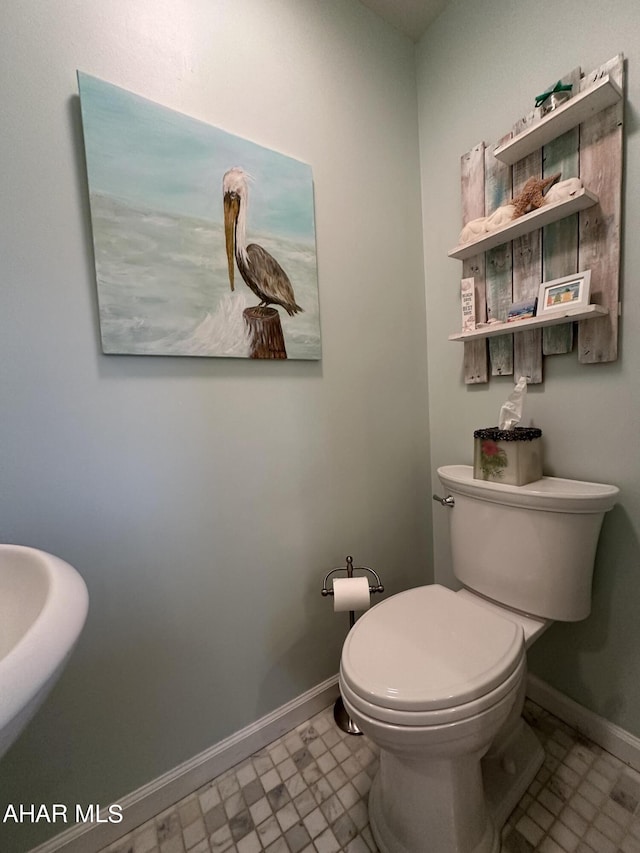 bathroom with tile patterned flooring and toilet