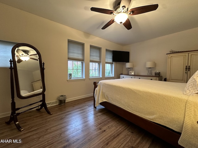 bedroom featuring ceiling fan and dark hardwood / wood-style flooring