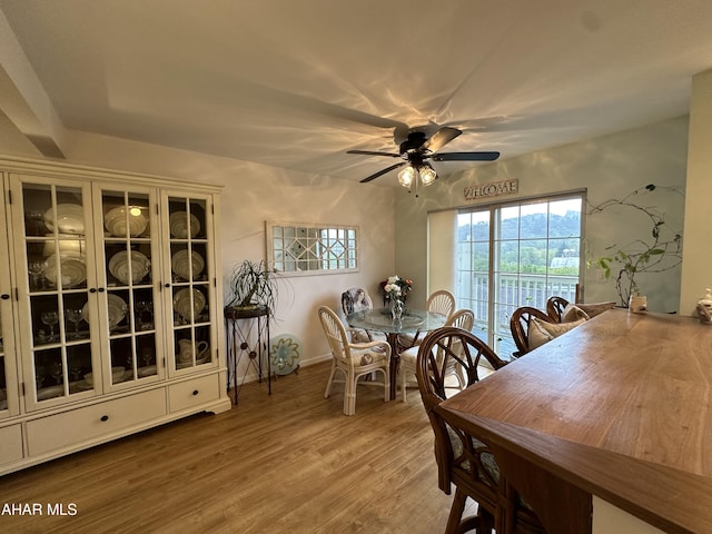 dining room with hardwood / wood-style floors and ceiling fan