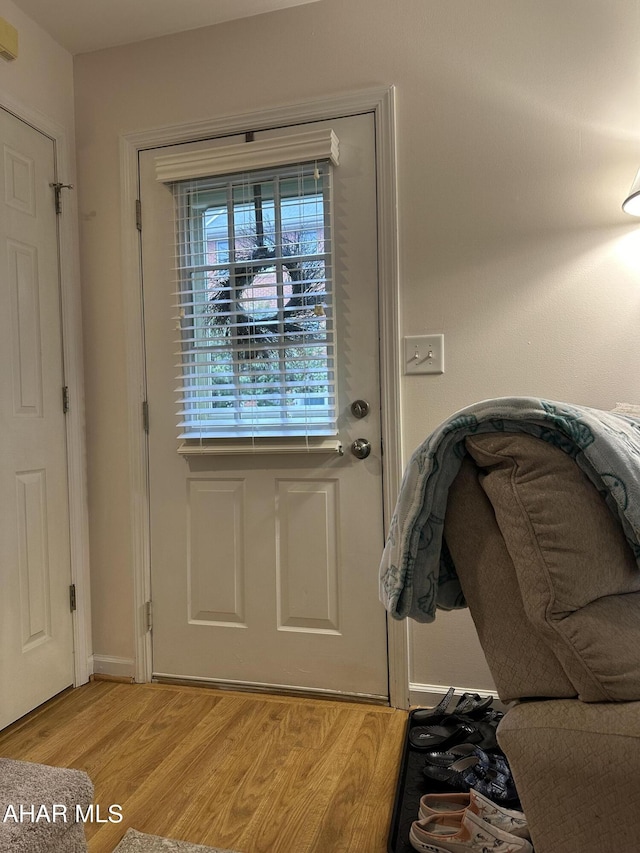 doorway to outside with light wood-type flooring