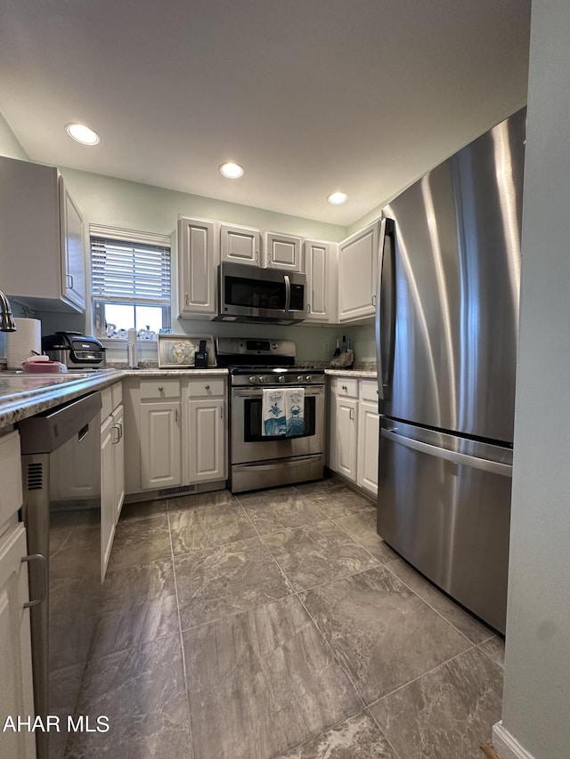 kitchen featuring white cabinetry, sink, and appliances with stainless steel finishes