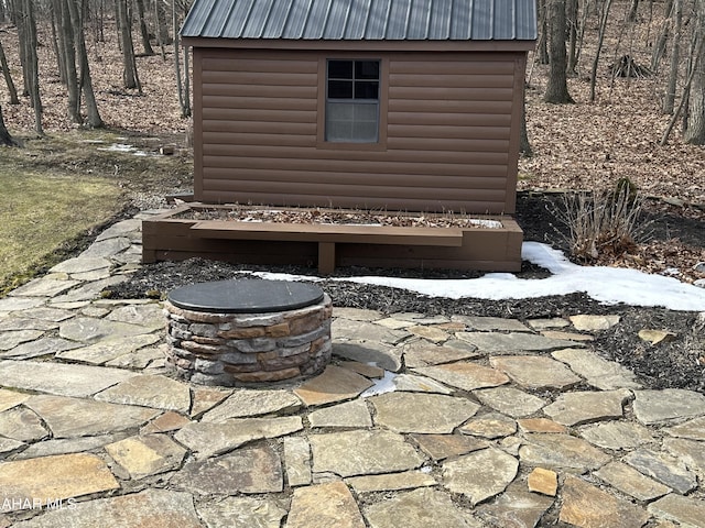 details featuring metal roof and faux log siding