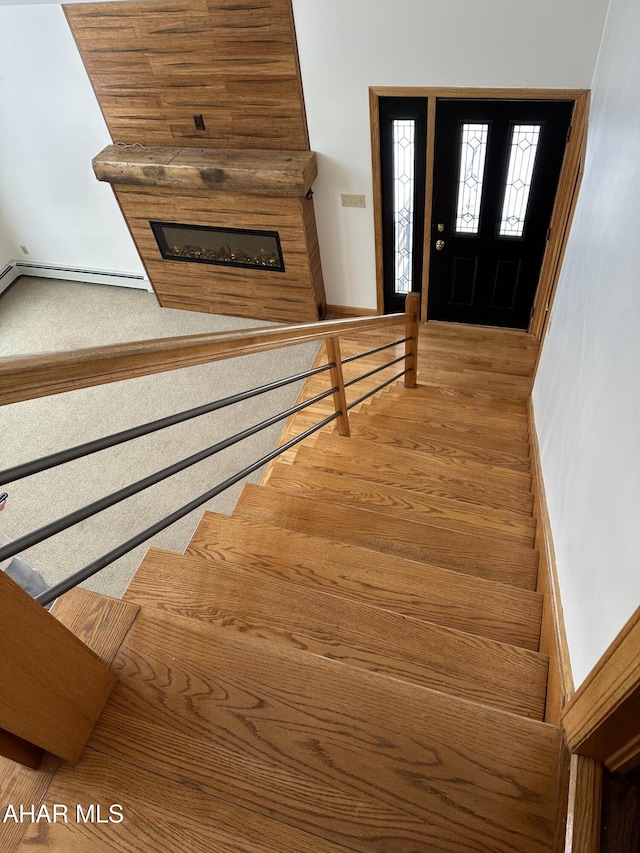 stairs featuring wood finished floors