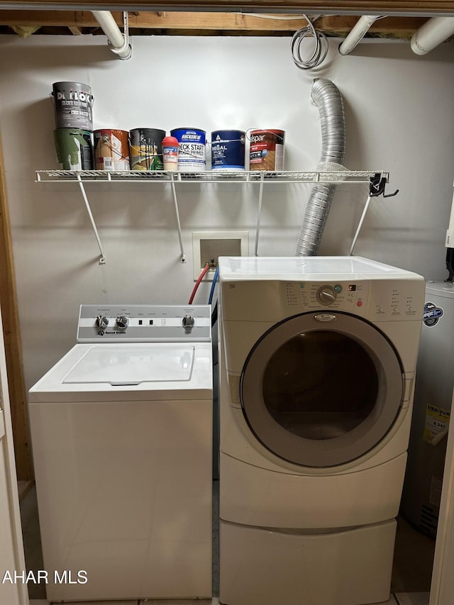 clothes washing area featuring washer and dryer and laundry area