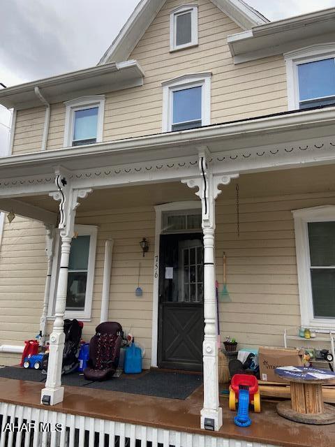 view of exterior entry featuring a porch