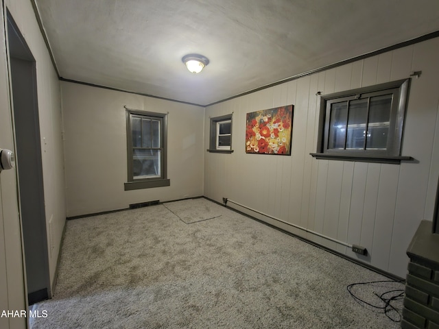 spare room featuring visible vents and carpet floors