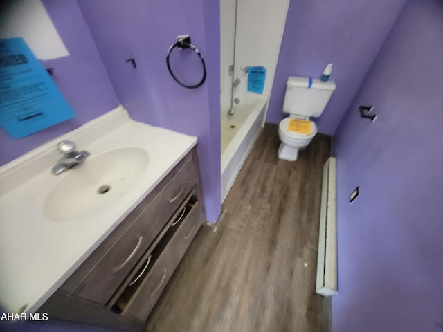 full bathroom with shower / bathtub combination, vanity, wood finished floors, and toilet