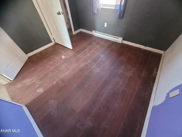 unfurnished bedroom featuring a baseboard radiator, dark wood-style flooring, and baseboards