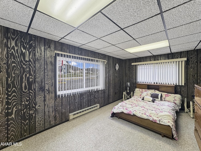 carpeted bedroom featuring a paneled ceiling and a baseboard radiator