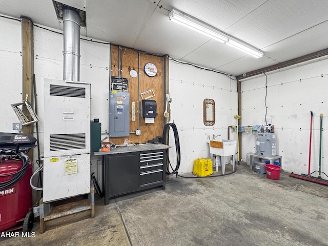 garage featuring a workshop area, electric panel, and sink