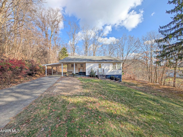 view of front of property with a front yard and a carport