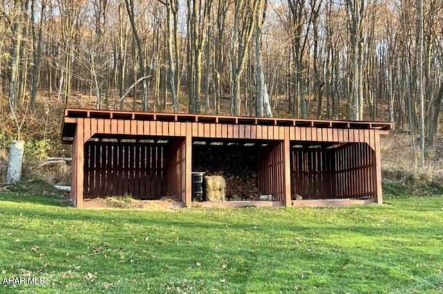 view of outbuilding featuring a lawn