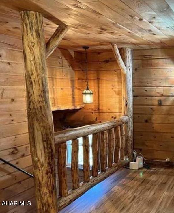 bonus room featuring wood ceiling, wooden walls, and hardwood / wood-style flooring