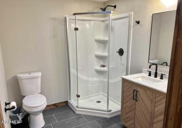 bathroom with walk in shower, vanity, toilet, and tile patterned flooring