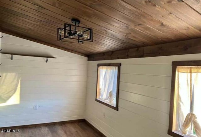 spare room featuring dark hardwood / wood-style floors, lofted ceiling, wooden walls, and wood ceiling