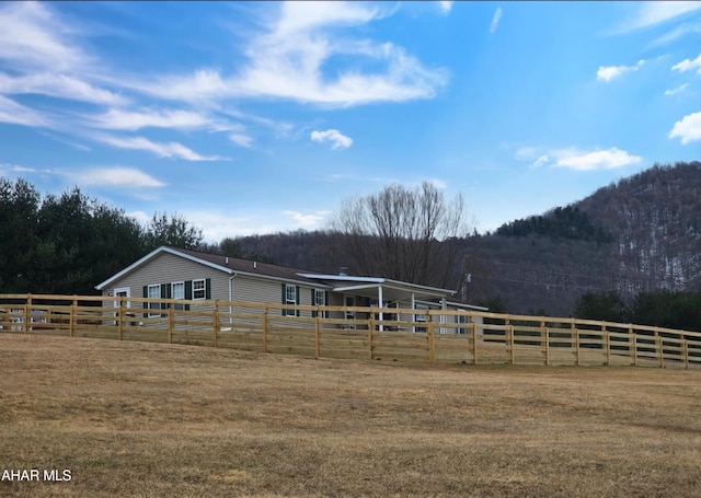 view of stable with a view of trees and a rural view