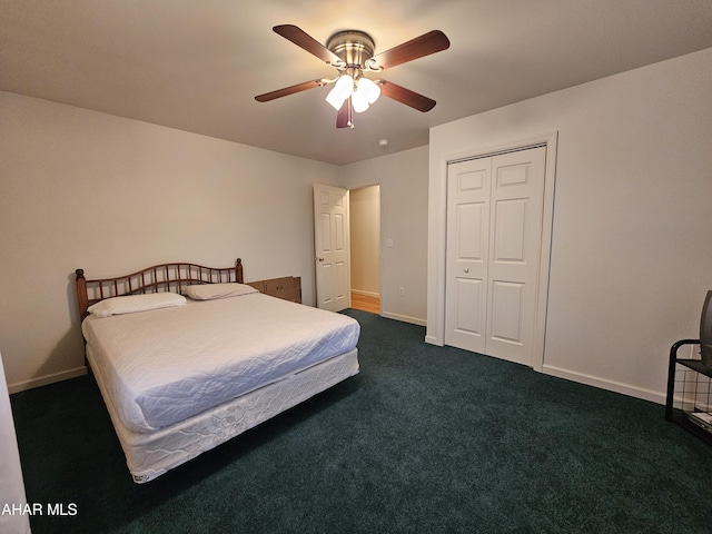 bedroom featuring a ceiling fan, dark colored carpet, a closet, and baseboards