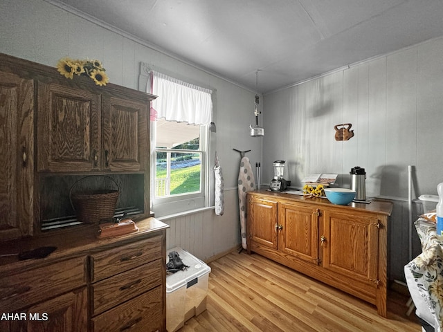 foyer entrance with hardwood / wood-style floors and a wood stove