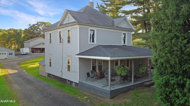 back of property with a porch