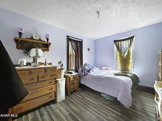 bedroom featuring dark hardwood / wood-style floors and a textured ceiling