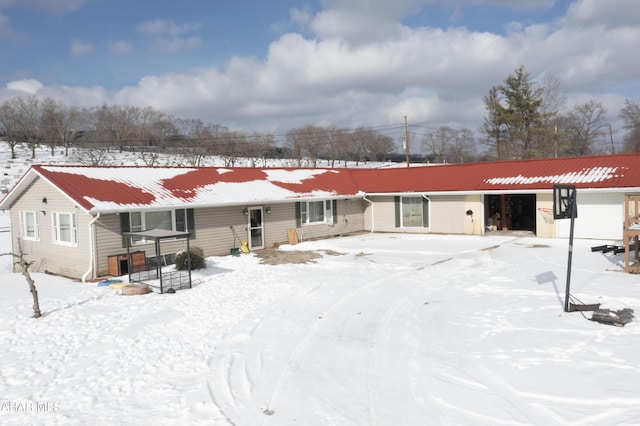 view of snow covered rear of property