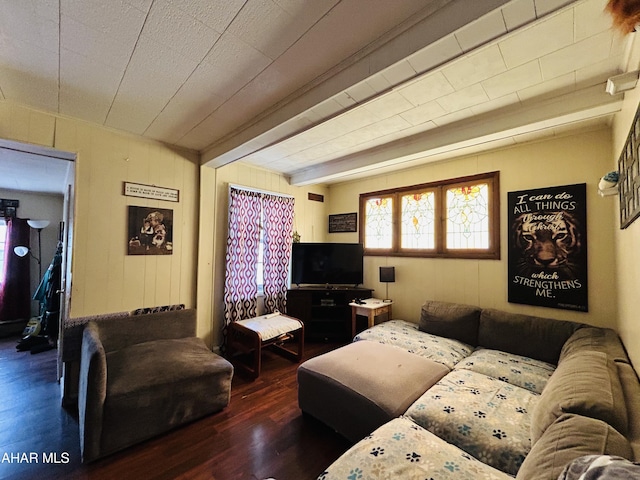 living area with wood finished floors and beamed ceiling
